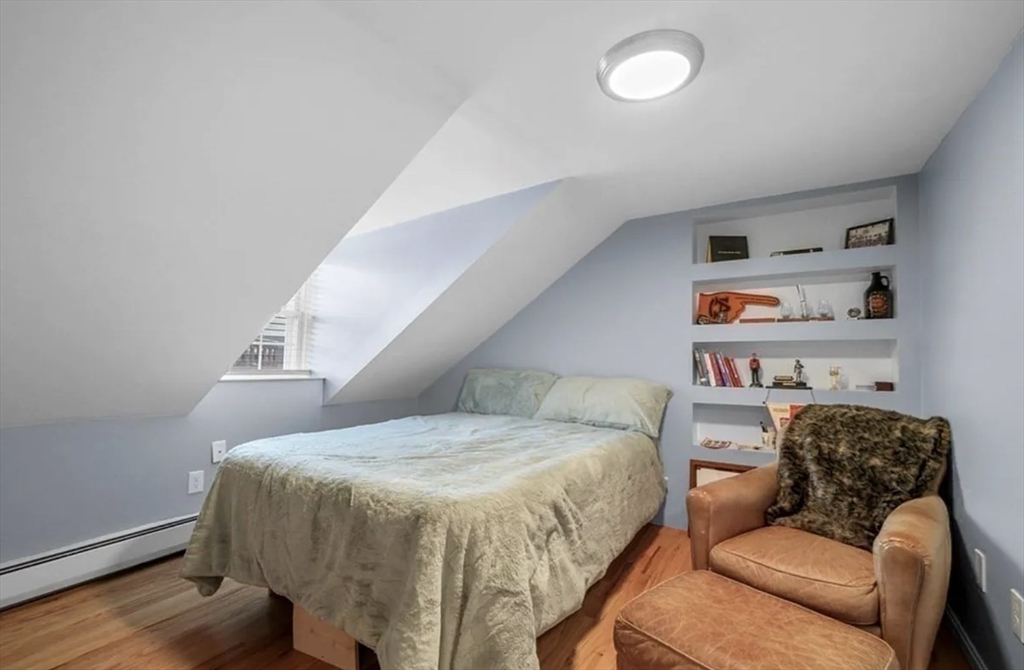 80 Park Street, Unit A Chelsea, MA 02150 - Photo 6 of 11 a bedroom with a bed and a couch