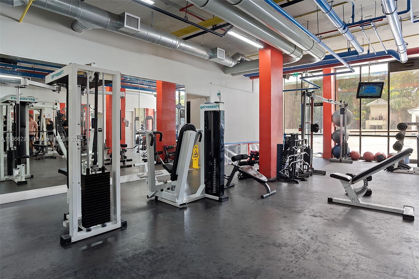 780 Northeast 69th Street, Unit 910 Miami, FL 33138 - Photo 24 of 26 a view of a room with gym equipment