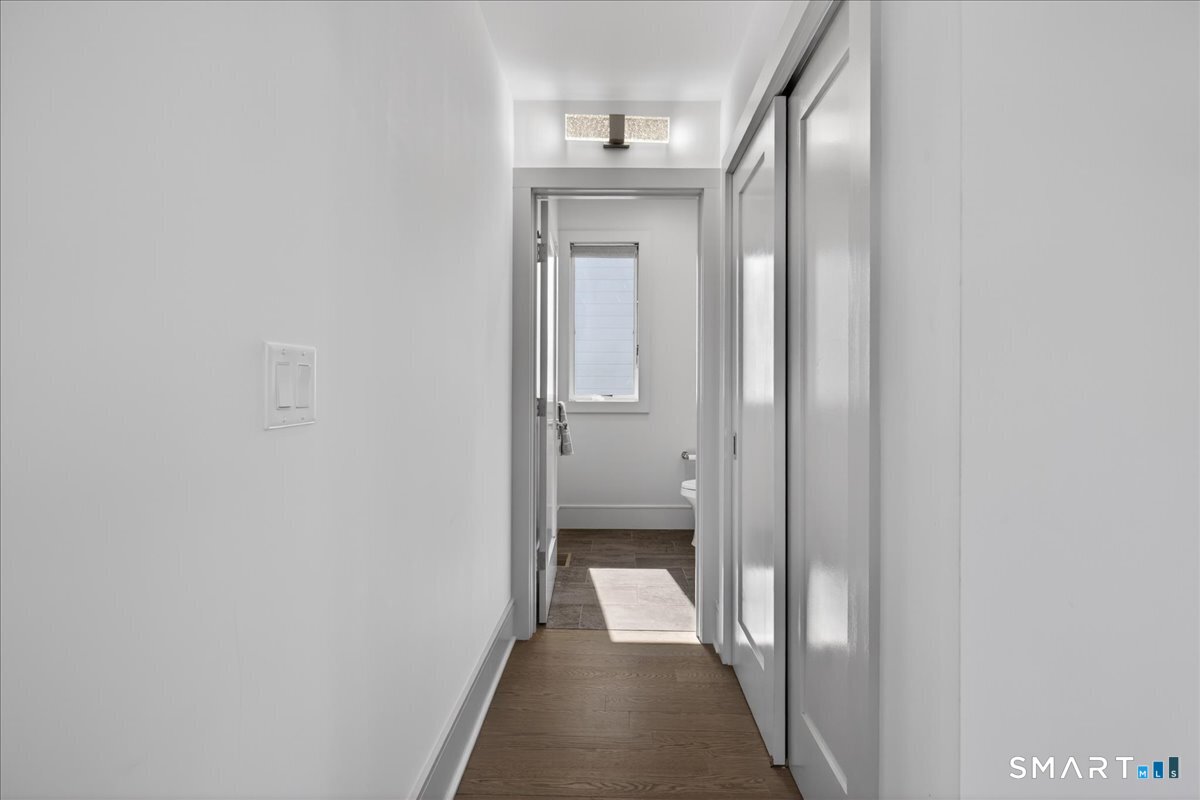 33 Pearl Street Milford, CT 06460 - Photo 15 of 40 a view of a hallway with wooden floor