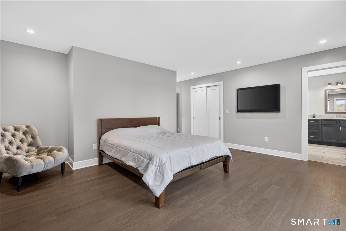 33 Pearl Street Milford, CT 06460 - Photo 19 of 40 a spacious bedroom with a bed and a flat screen tv
