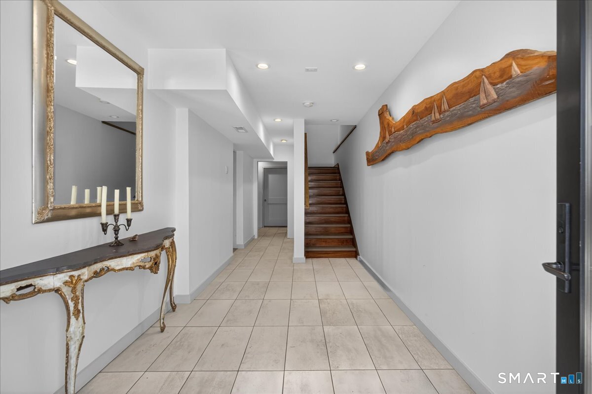 33 Pearl Street Milford, CT 06460 - Photo 2 of 40 a hallway with entryway a sink and a mirror