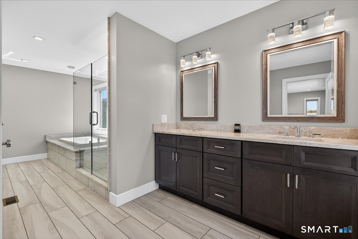 33 Pearl Street Milford, CT 06460 - Photo 21 of 40 a bathroom with a double vanity sink mirror and bathtub