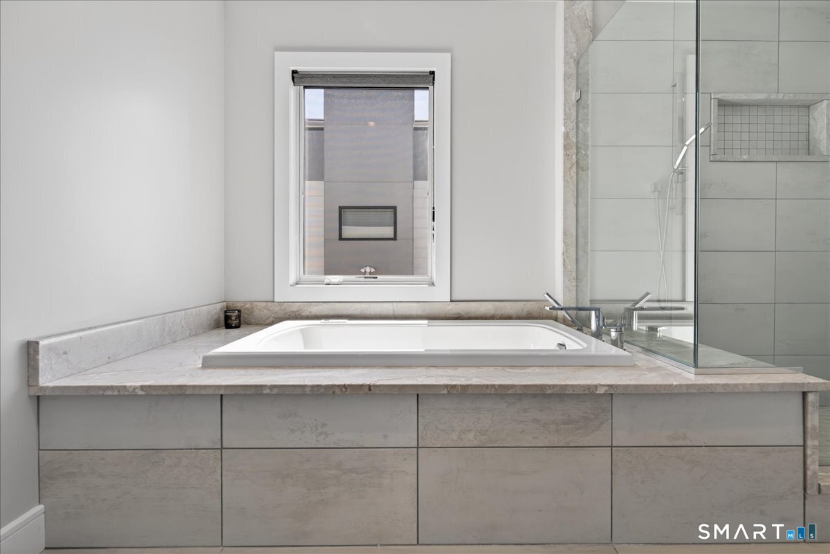 33 Pearl Street Milford, CT 06460 - Photo 22 of 40 a bathroom with a sink and a mirror