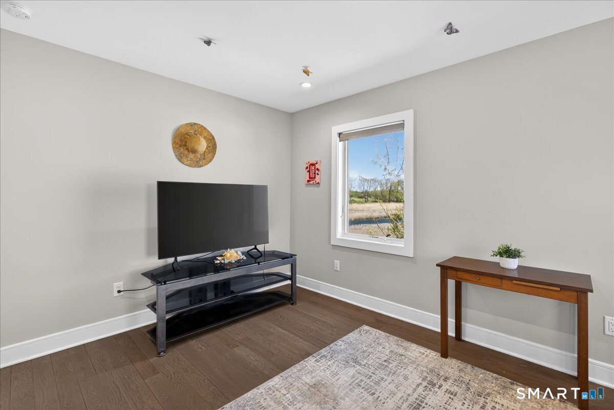 33 Pearl Street Milford, CT 06460 - Photo 25 of 40 a living room with furniture and a flat screen tv