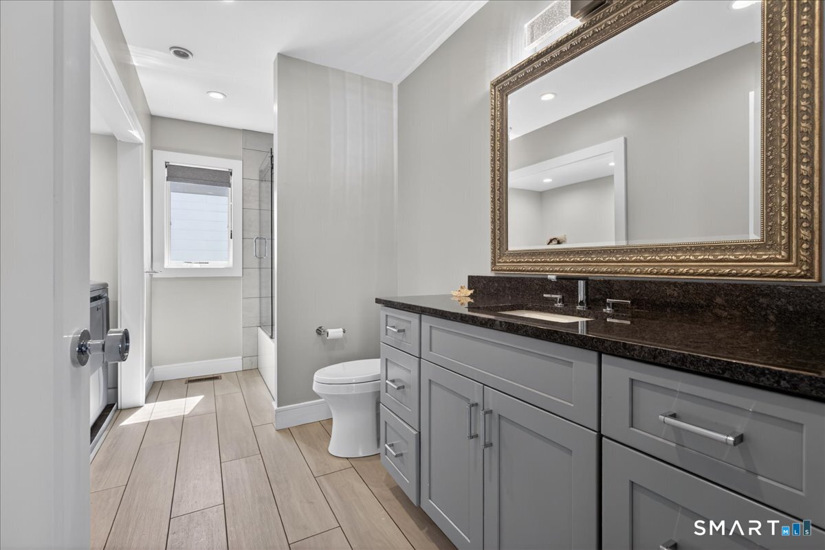 33 Pearl Street Milford, CT 06460 - Photo 27 of 40 a bathroom with a sink a toilet and a mirror