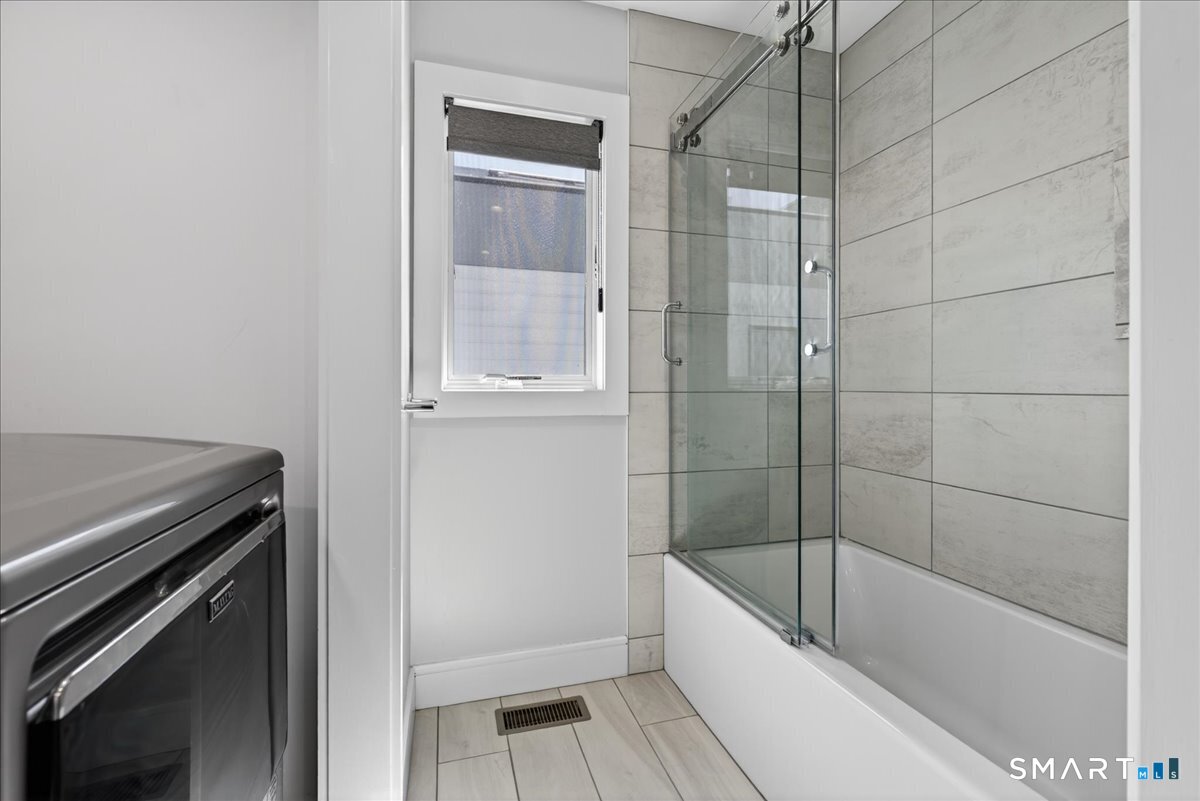33 Pearl Street Milford, CT 06460 - Photo 28 of 40 a bathroom with a bathtub and a shower