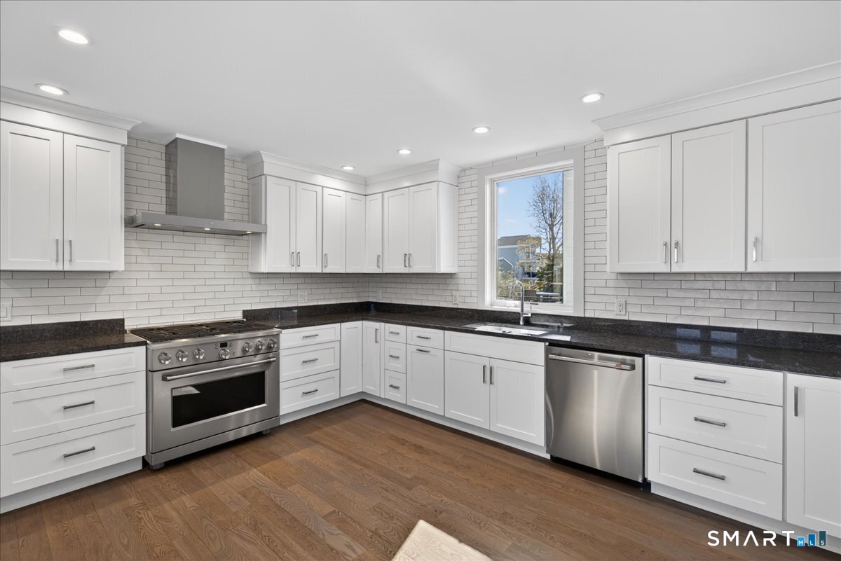 33 Pearl Street Milford, CT 06460 - Photo 8 of 40 a kitchen with granite countertop white cabinets and white stainless steel appliances