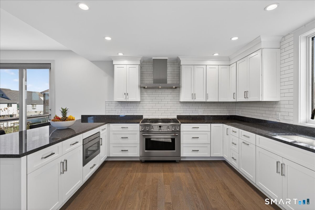 33 Pearl Street Milford, CT 06460 - Photo 9 of 40 a kitchen with granite countertop white cabinets and white appliances