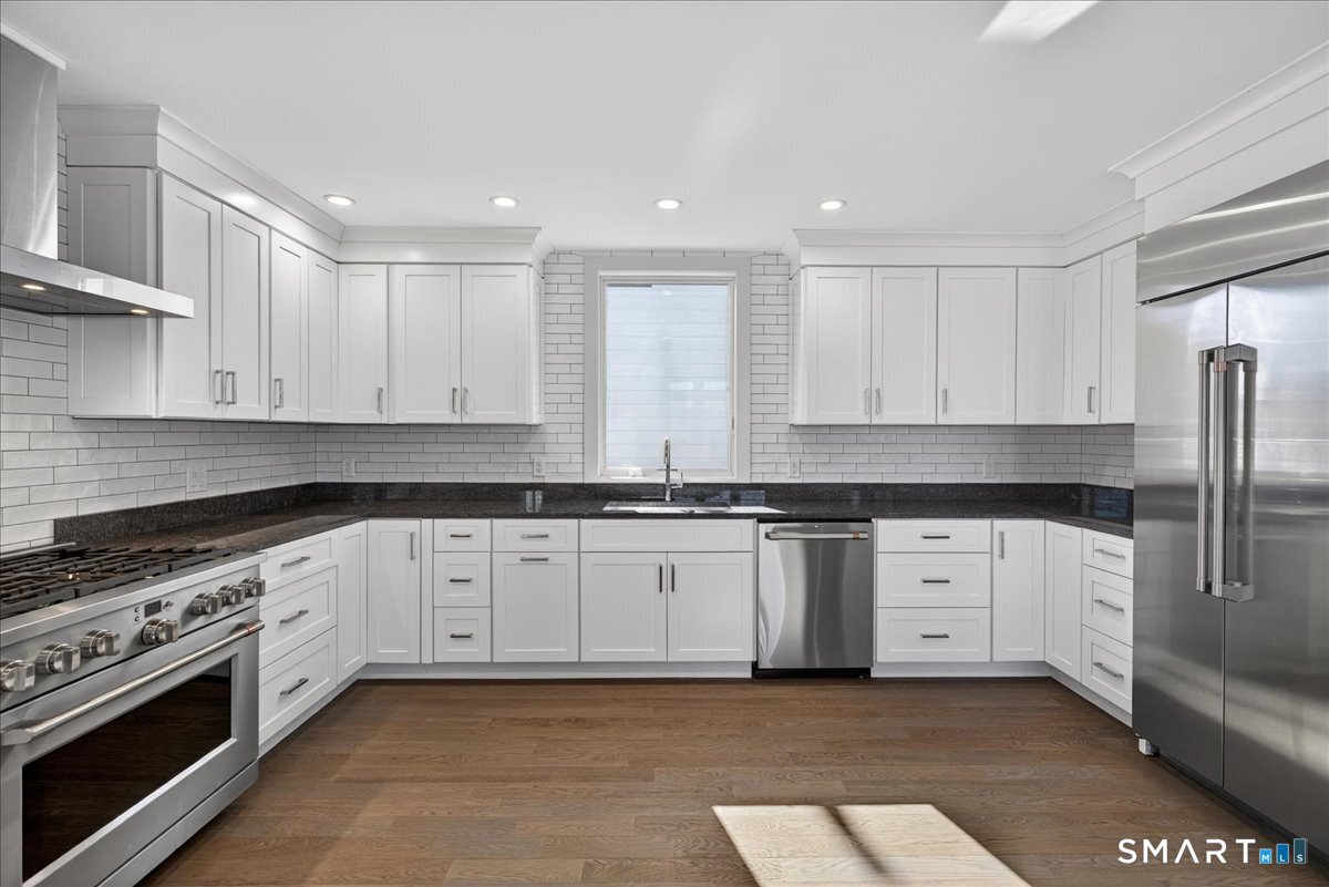 33 Pearl Street Milford, CT 06460 - Photo 10 of 40 a kitchen with stainless steel appliances granite countertop a stove a sink and a refrigerator