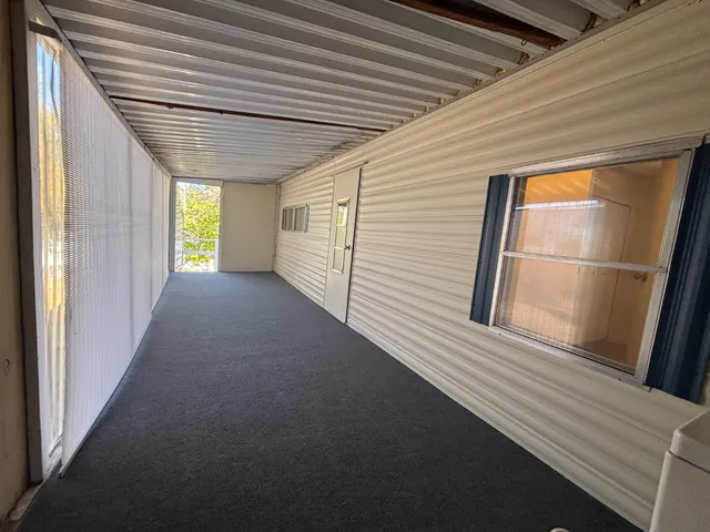 a view of a porch with wooden floor