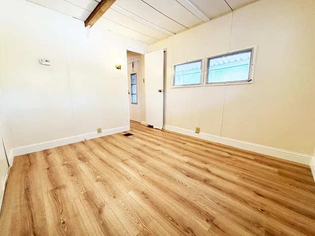 a view of a room with wooden floor
