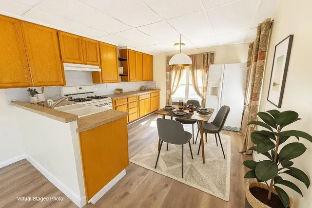 a view of a dining room with furniture and a window