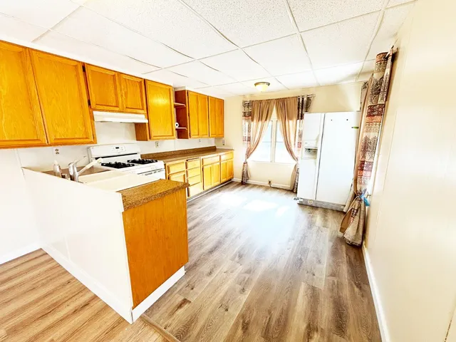 a kitchen with stainless steel appliances a stove a sink and a refrigerator