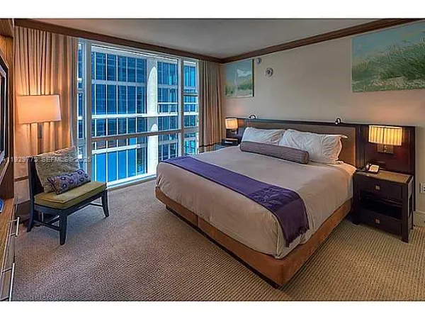 a spacious bedroom with a bed and a couch