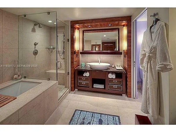 a spacious bathroom with a granite countertop tub sink and mirror