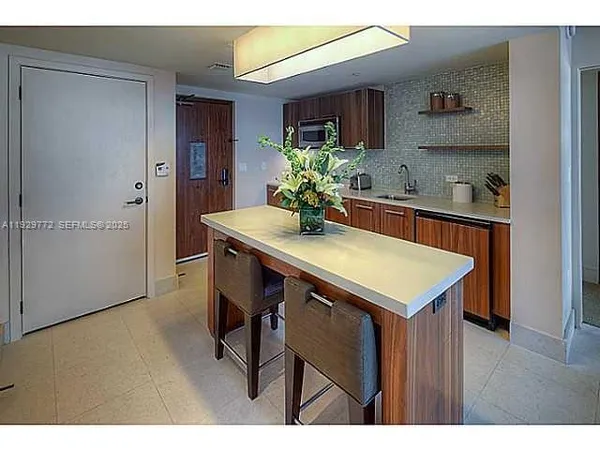 a kitchen with a table and chairs in it