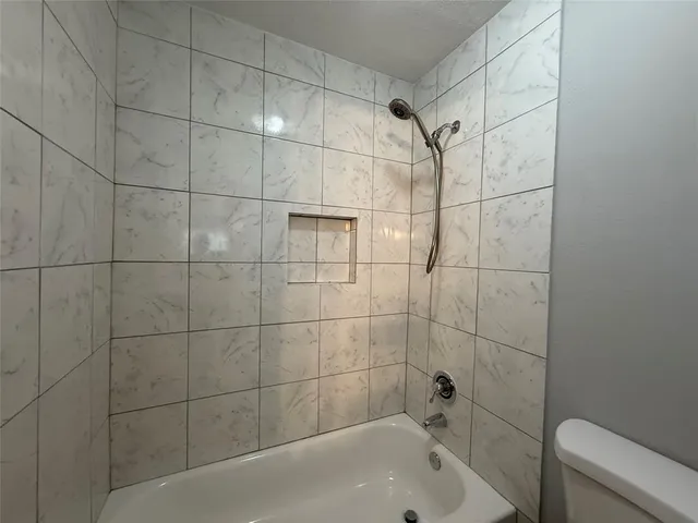 a bathroom with a bathtub and shower