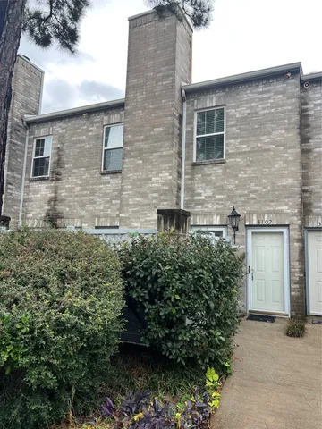 a brick building with a yard