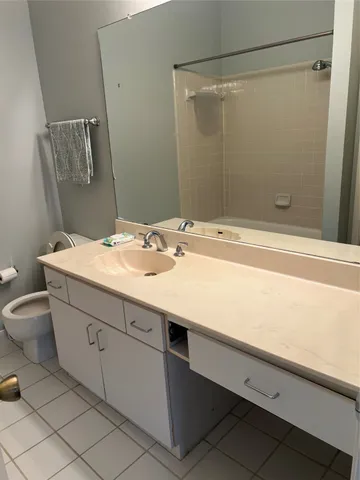 a bathroom with a shower and a sink