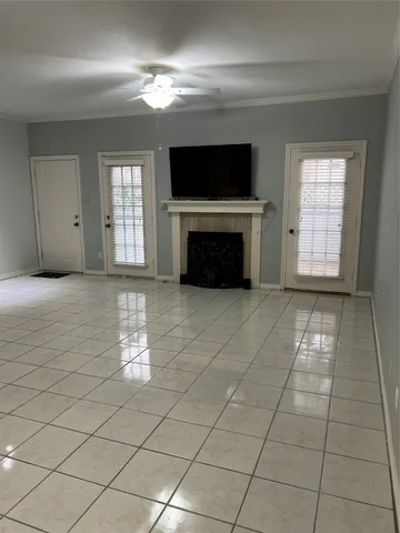 a view of a livingroom with a fireplace window and table chair