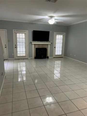 a view of an empty room with a fireplace and a window