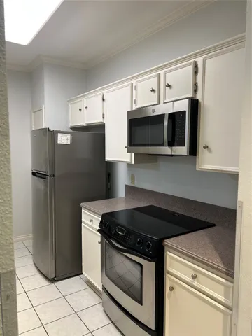 a kitchen with a refrigerator stove and microwave