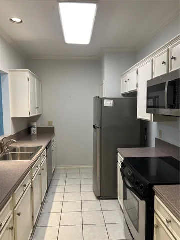 a kitchen with a sink a stove and cabinets