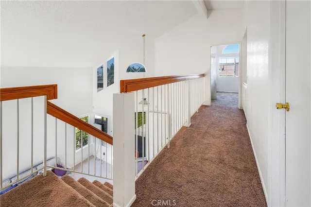 a view of a hallway with wooden floor and entryway