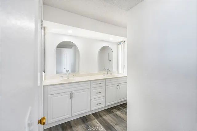 a bathroom with double vanity sinks and a mirror