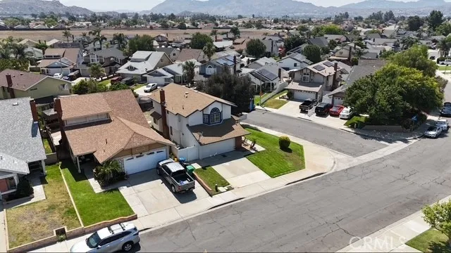 an aerial view of a house with a garden and lake view