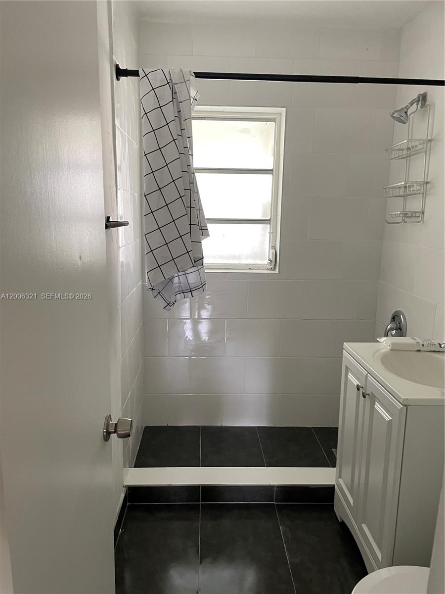 5800 Southwest 61st Street Miami, FL 33143 - Photo 11 of 23 a bathroom with a sink and a shower