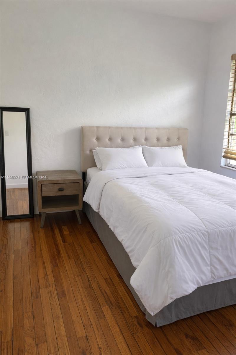 5800 Southwest 61st Street Miami, FL 33143 - Photo 13 of 23 a bedroom with a bed and wooden floor