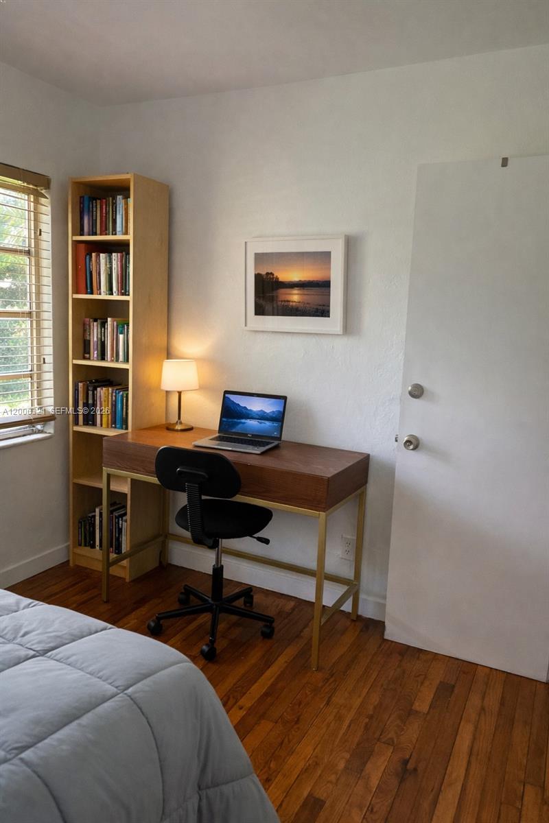 5800 Southwest 61st Street Miami, FL 33143 - Photo 14 of 23 a bedroom with a bed and a bookshelf
