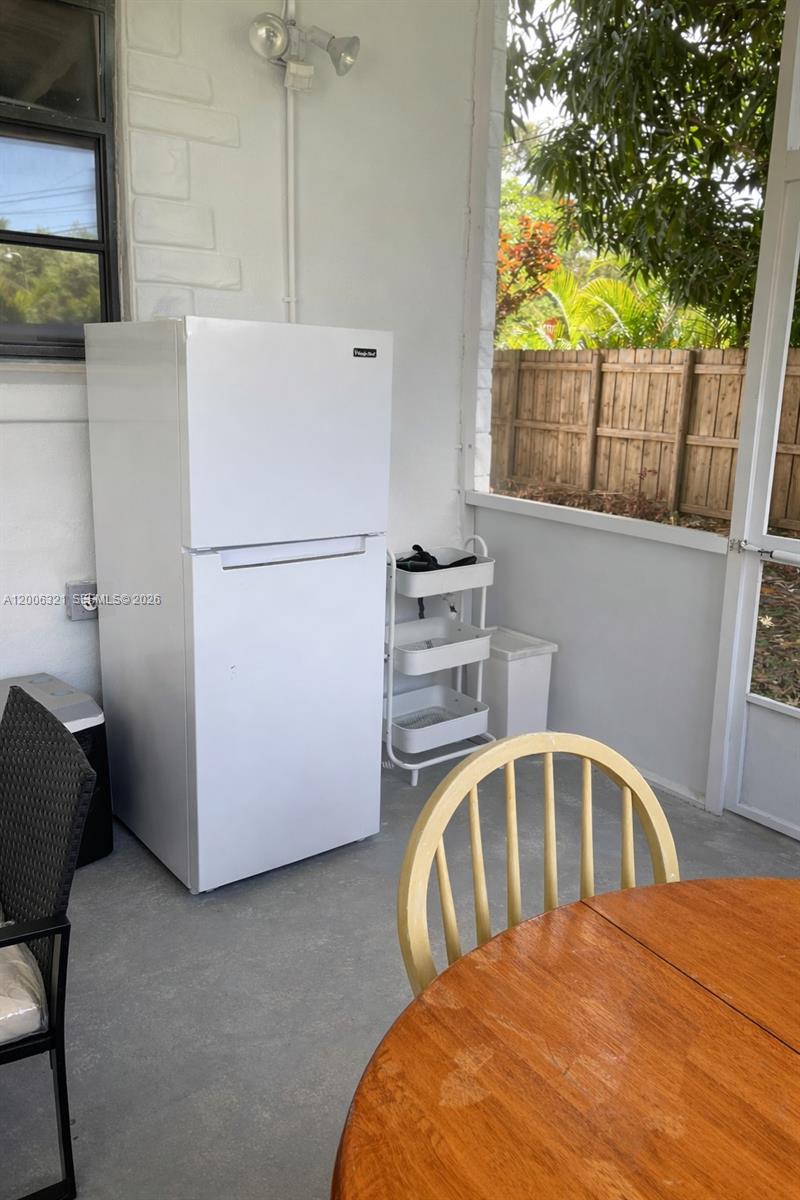 5800 Southwest 61st Street Miami, FL 33143 - Photo 17 of 23 a white refrigerator freezer sitting in a kitchen