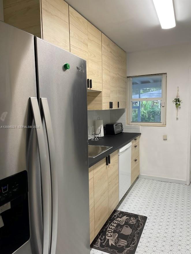 5800 Southwest 61st Street Miami, FL 33143 - Photo 20 of 23 a kitchen with stainless steel appliances granite countertop a refrigerator and a sink