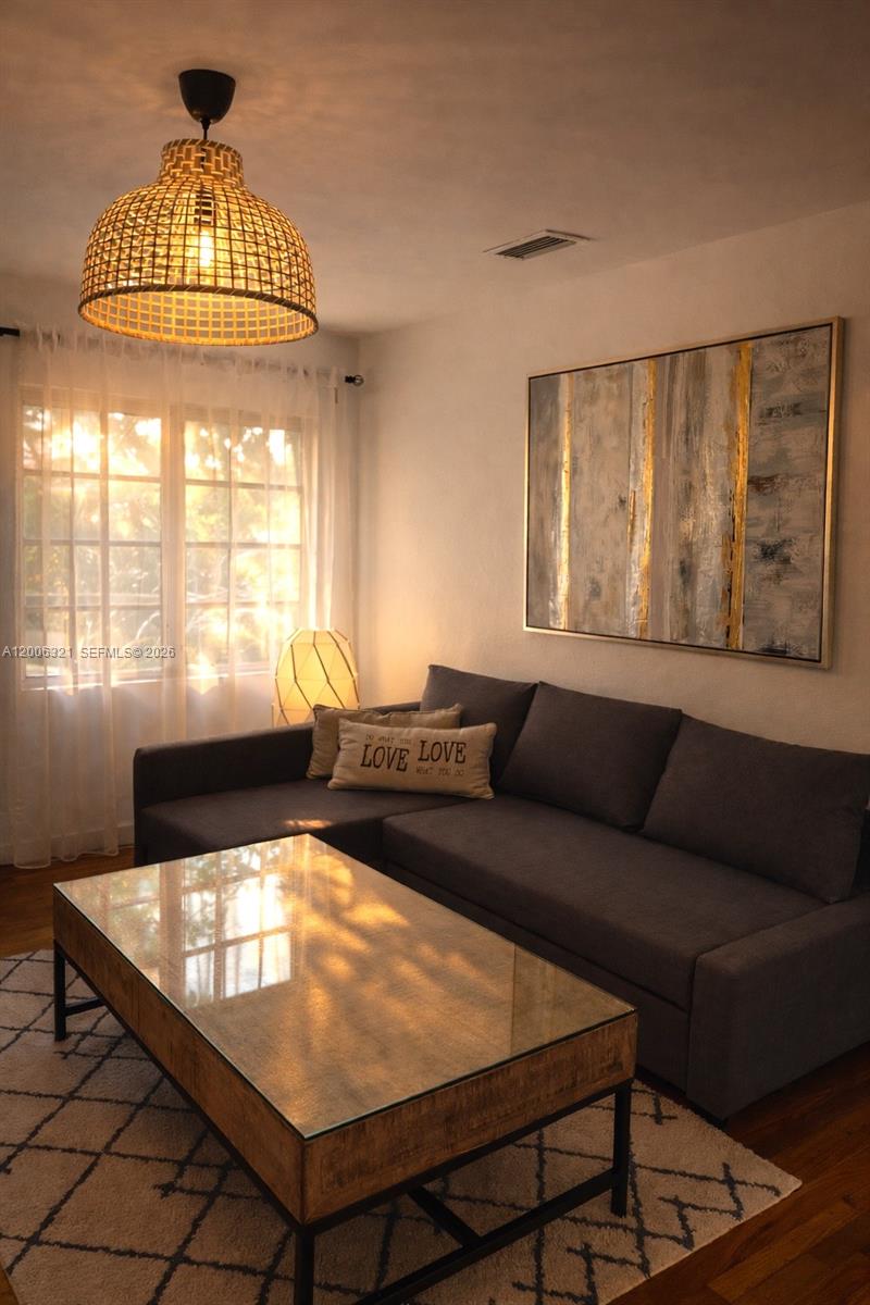 5800 Southwest 61st Street Miami, FL 33143 - Photo 2 of 23 a living room with a couch and a chandelier
