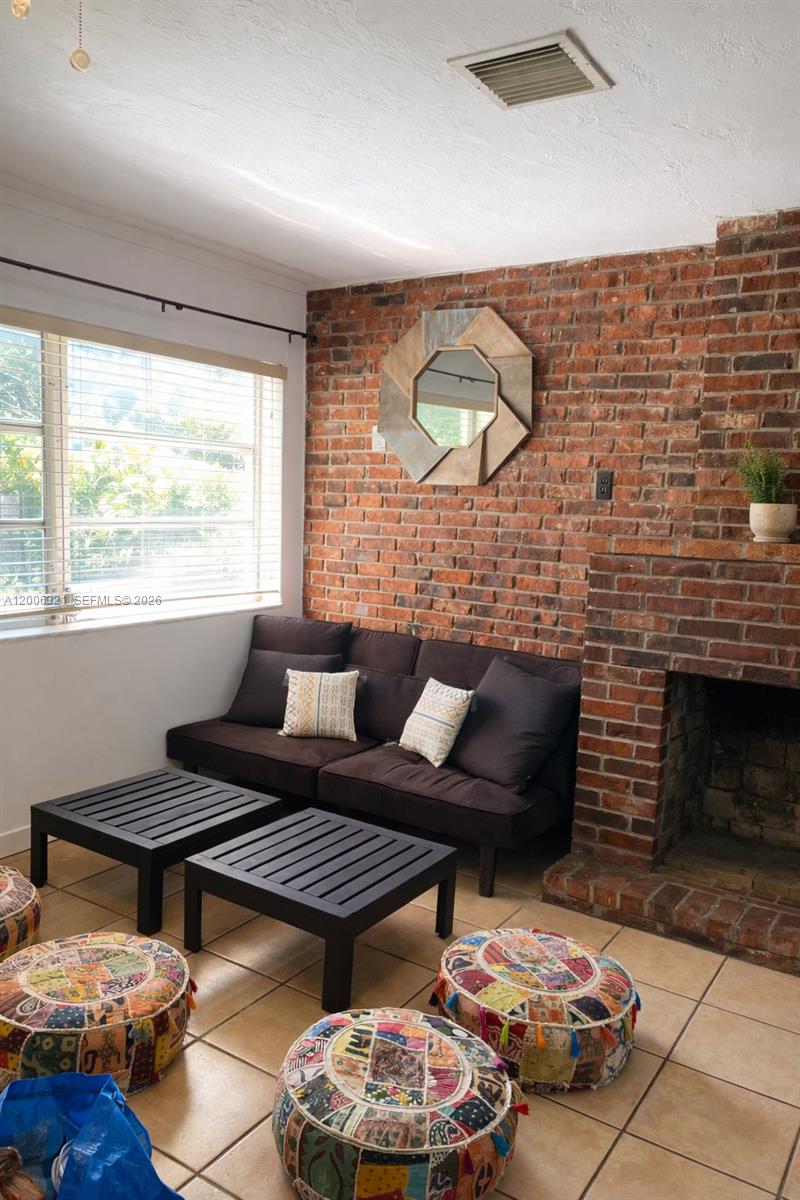 5800 Southwest 61st Street Miami, FL 33143 - Photo 9 of 23 a living room with furniture and a fireplace