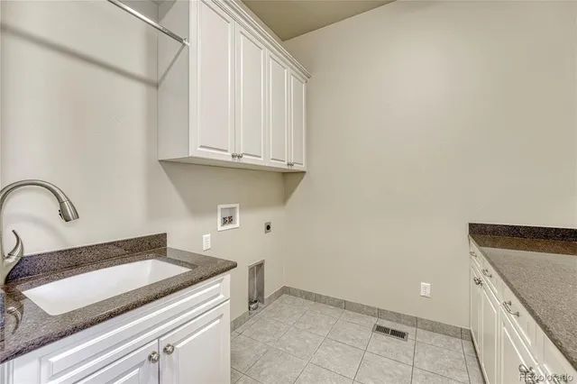 a bathroom with a granite countertop sink a toilet and bathtub
