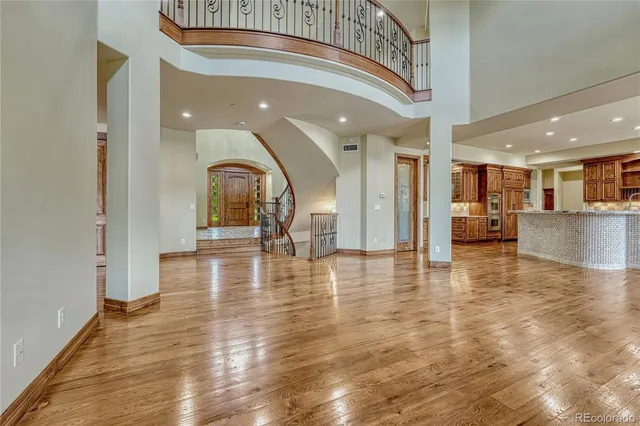 a large bathroom with a granite countertop double vanity sink a mirror and a bathtub