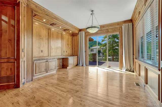 a bathroom with a granite countertop sink a toilet and a large mirror