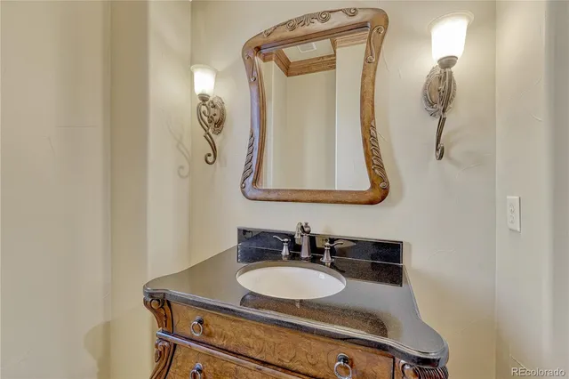 a spacious bathroom with a granite countertop sink and a large mirror