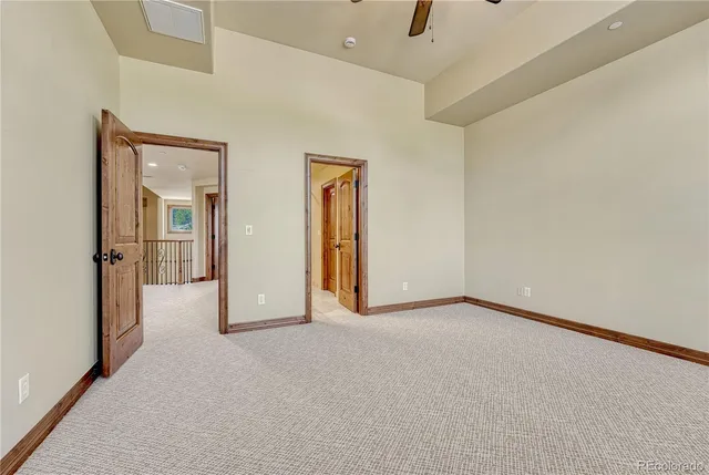 a view of empty room with wooden floor fireplace and a window