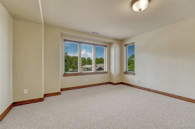 a front view of a house with yard and green space