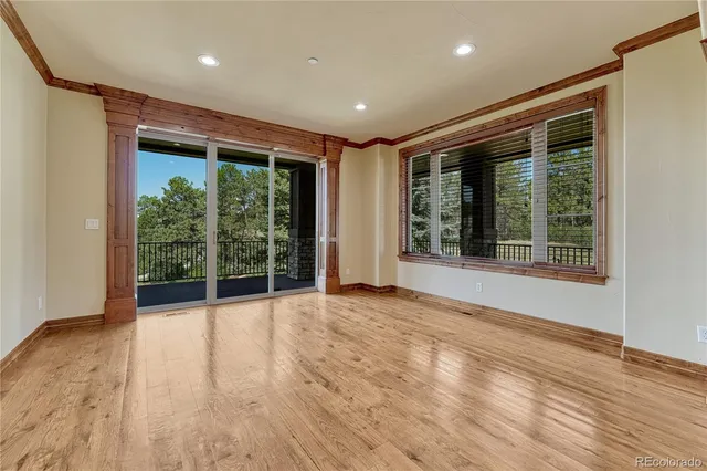 a view of an empty room with wooden floor