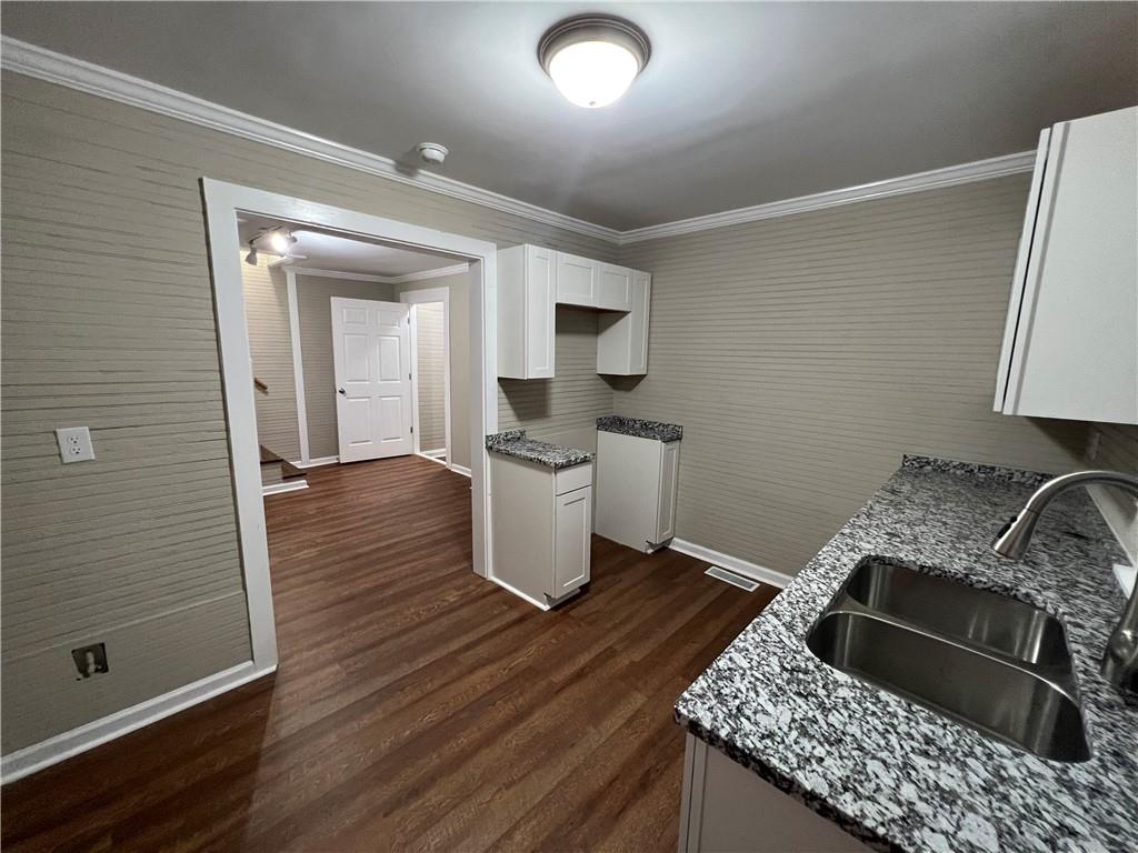 15 Tower Street Gainesville, GA 30501 - Photo 4 of 9 a kitchen with granite countertop a stove and cabinets