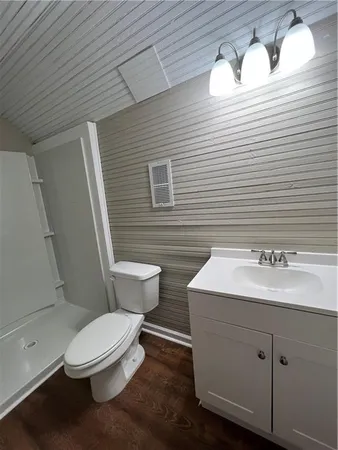 a bathroom with a sink a toilet and mirror