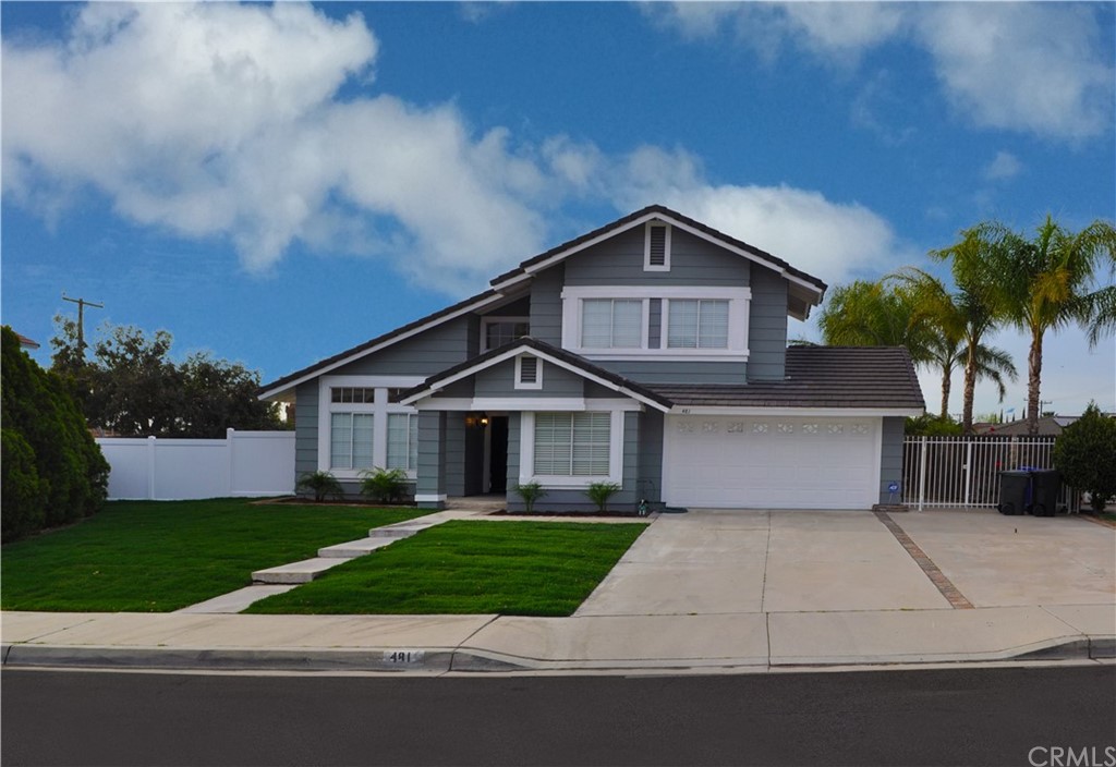 481 West Hawthorne Street Rialto, CA 92376 - Photo 1 of 1 a front view of a house with a yard and garage
