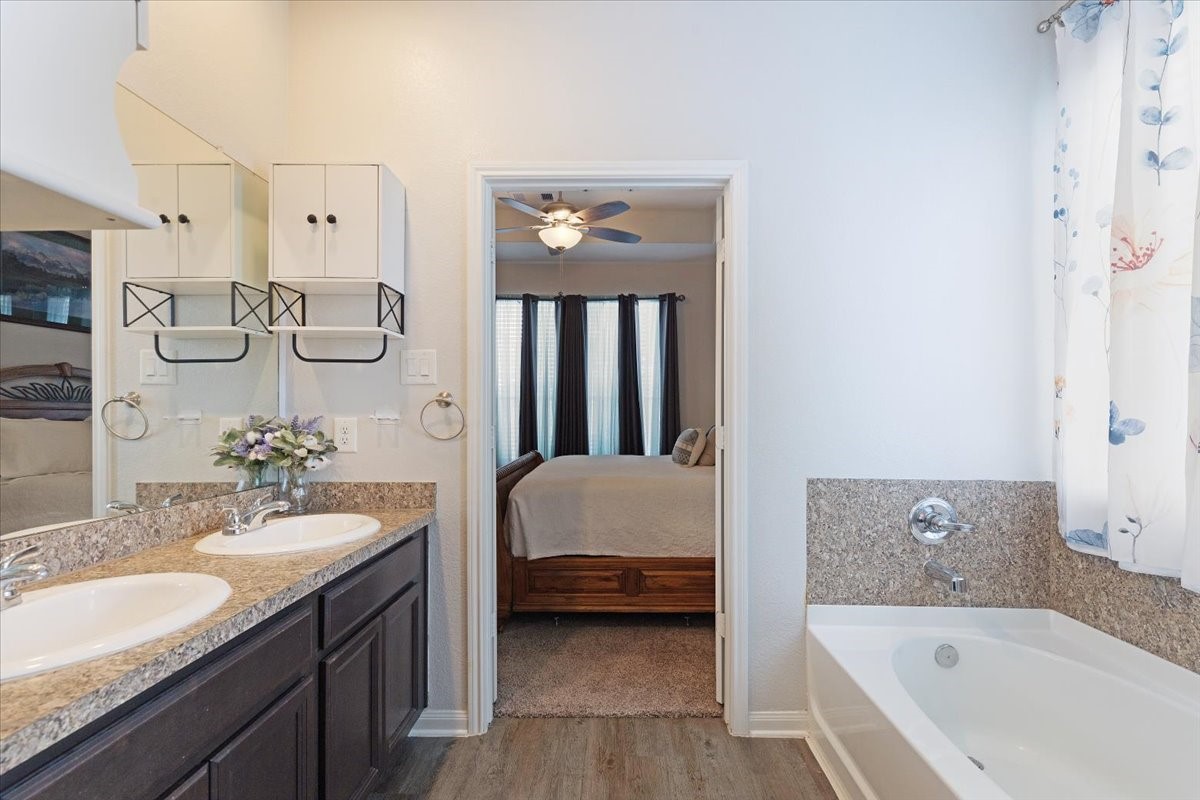 1685 County Road 5102 East Cleveland, TX 77327 - Photo 15 of 31 a en suite bathroom with a tub double sink and mirror