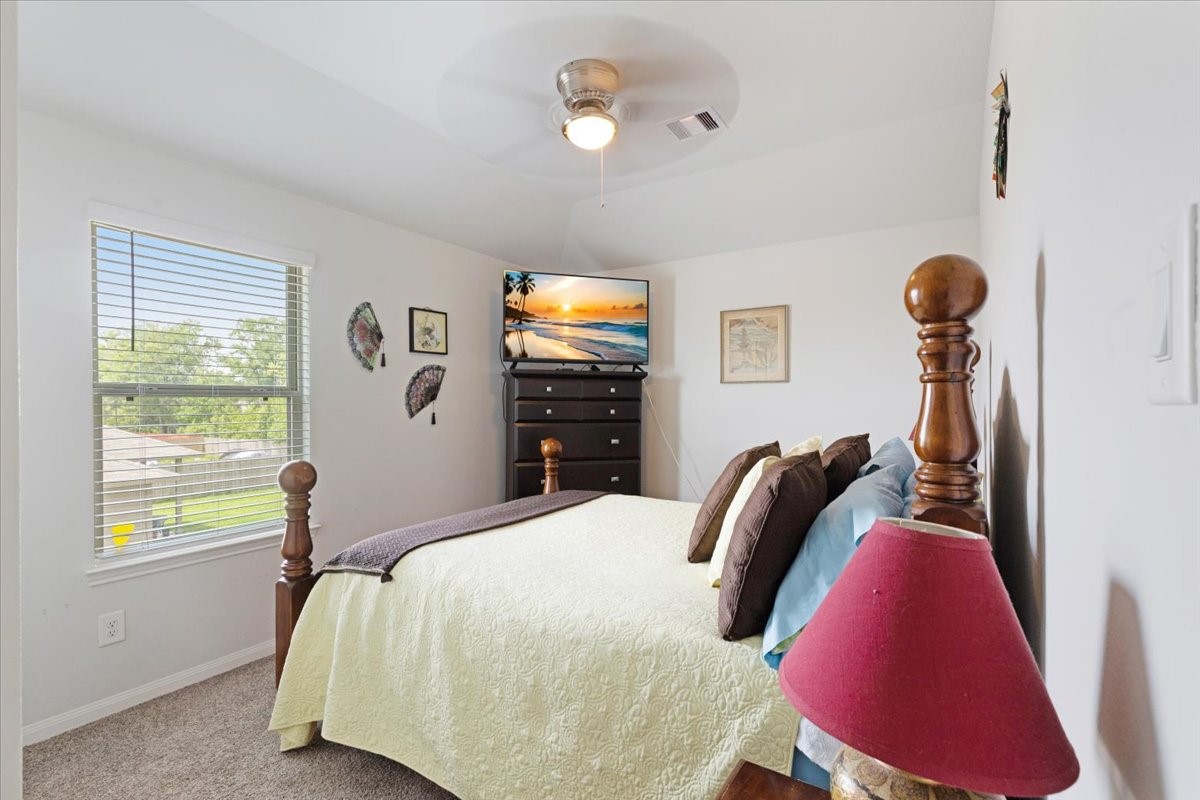 1685 County Road 5102 East Cleveland, TX 77327 - Photo 19 of 31 a bedroom with bed and a window