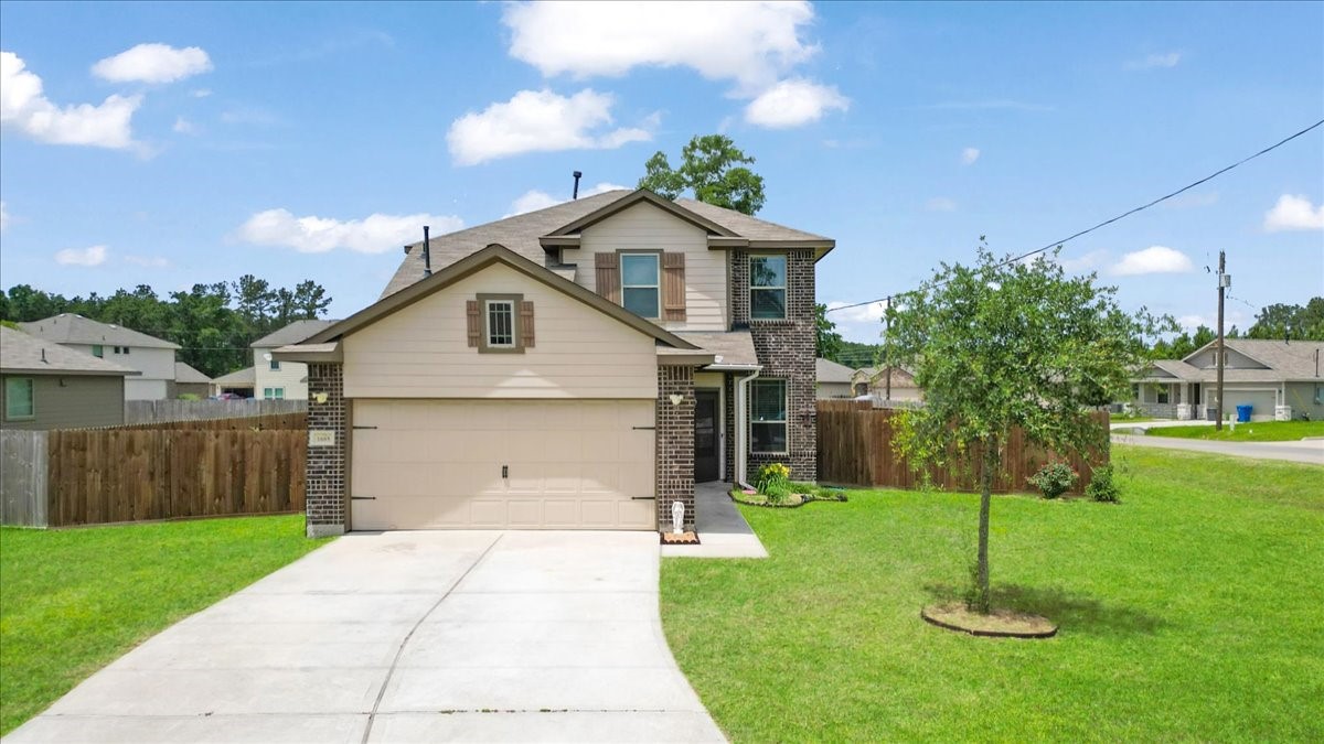 1685 County Road 5102 East Cleveland, TX 77327 - Photo 2 of 31 a front view of a house with a yard and green space